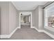 Bright living room with neutral carpet, light walls, windows, and an open doorway, offering a connected and airy feel at 3345 Ruckle St, Indianapolis, IN 46205