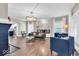 Open living room featuring hardwood floors, a decorative light fixture, and ample seating at 3345 Ruckle St, Indianapolis, IN 46205