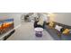 Open living room area features large TV, gray couch, modern furniture, and neutral carpet at 3345 Ruckle St, Indianapolis, IN 46205