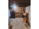 Unfinished basement area with exposed ceiling and organized storage at 3422 Hillside Ave, Indianapolis, IN 46218