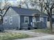 A charming one-story home with gray siding, dark roof, and inviting front porch, perfect for relaxing outdoors at 3422 Hillside Ave, Indianapolis, IN 46218