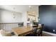 Bright dining room with a wooden table, black chairs, and modern lighting at 3535 Buckner Dr, Westfield, IN 46074