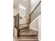 Stylish entryway with wood stairs, modern railing, and a charming woven accent cabinet at 3535 Buckner Dr, Westfield, IN 46074