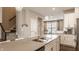 Well-lit kitchen with stainless steel appliances and a view to the dining area and staircase at 3535 Buckner Dr, Westfield, IN 46074