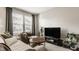Cozy living room featuring a plush sofa, accent chair, and a sleek television at 3535 Buckner Dr, Westfield, IN 46074