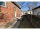 Backyard with brick home, walkway and storage shed at 3618 Spann Ave, Indianapolis, IN 46203