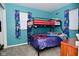 bedroom with bunkbeds, blue walls, and colorful curtains at 3618 Spann Ave, Indianapolis, IN 46203