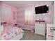Bright bedroom with colorful chevron wall design, white furniture, and large television at 3618 Spann Ave, Indianapolis, IN 46203