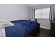 Bedroom with dark blue bedding, hardwood floors and ample natural light at 3618 Spann Ave, Indianapolis, IN 46203