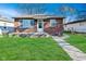Charming brick home with a well-manicured lawn and inviting front porch, complete with a lovely walkway at 3618 Spann Ave, Indianapolis, IN 46203