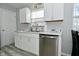 Well-lit kitchen with white cabinets, stainless steel dishwasher, and modern countertops at 3618 Spann Ave, Indianapolis, IN 46203