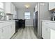 Modern kitchen featuring stainless steel appliances, gray floor, and white cabinetry at 3618 Spann Ave, Indianapolis, IN 46203