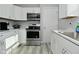Modern kitchen with stainless steel oven, white cabinets, and updated countertops at 3618 Spann Ave, Indianapolis, IN 46203