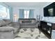 Bright living room with ample seating, modern TV, and decorative curtains at 3618 Spann Ave, Indianapolis, IN 46203