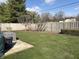 Fenced backyard featuring a lush lawn, mature trees, and a patio area, ideal for outdoor entertaining at 3760 Briar Hill Way, Columbus, IN 47203
