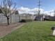 Spacious backyard with green lawn, complemented by a wooden fence and budding trees at 3760 Briar Hill Way, Columbus, IN 47203