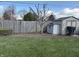 Lush backyard with a well-maintained lawn, shed, and privacy fence at 3760 Briar Hill Way, Columbus, IN 47203