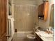 Functional bathroom with a shower-tub combo, vanity, and wood cabinets at 3760 Briar Hill Way, Columbus, IN 47203