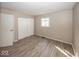 Bedroom featuring neutral paint, wood-look floors and closet space at 4008 N Mitthoefer Rd, Indianapolis, IN 46235