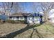 Charming single-story home featuring a blue exterior, well-kept yard, and mature trees at 4008 N Mitthoefer Rd, Indianapolis, IN 46235