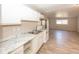 Open kitchen featuring white cabinets, marble-look countertops, and modern appliances at 4008 N Mitthoefer Rd, Indianapolis, IN 46235