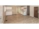 Open-concept living space with bright white kitchen, hardwood floors, and neutral walls at 4008 N Mitthoefer Rd, Indianapolis, IN 46235