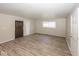 Spacious living room with wood-look flooring and natural light from windows at 4008 N Mitthoefer Rd, Indianapolis, IN 46235