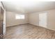 An open living room offering ample light and modern wood flooring at 4008 N Mitthoefer Rd, Indianapolis, IN 46235