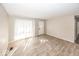Spacious living room with new wood flooring and large windows bringing in natural light at 4008 N Mitthoefer Rd, Indianapolis, IN 46235
