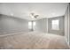 This large bedroom features carpet, a ceiling fan, and three large windows offering plenty of natural light at 4241 Risen Star Way, Bargersville, IN 46106