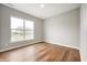 This bedroom features wood-look floors, gray walls, and a large window offering plenty of natural light at 4241 Risen Star Way, Bargersville, IN 46106