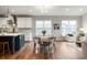 Open dining area with a view of the kitchen and living room, featuring a dining table and modern chairs at 4241 Risen Star Way, Bargersville, IN 46106