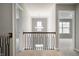 This hallway features wood railings, carpet, and a modern chandelier at 4241 Risen Star Way, Bargersville, IN 46106