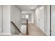 Bright hallway boasts neutral colors, a staircase, and a double-door closet for convenient storage at 4241 Risen Star Way, Bargersville, IN 46106