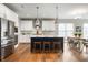 Spacious kitchen with white cabinets, stainless steel appliances, and a navy blue island at 4241 Risen Star Way, Bargersville, IN 46106