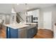 Kitchen island with stainless steel sink and dishwasher, complemented by hardwood floors and white cabinetry at 4241 Risen Star Way, Bargersville, IN 46106
