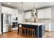 Bright kitchen with white cabinets, stainless steel appliances, and a large kitchen island at 4241 Risen Star Way, Bargersville, IN 46106