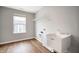The laundry room features wood-look floors, utility sink, and storage shelves for optimal organization at 4241 Risen Star Way, Bargersville, IN 46106