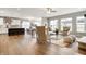 Open-concept living area showcasing the hardwood flooring, neutral color palette, kitchen, dining, and natural light at 4241 Risen Star Way, Bargersville, IN 46106