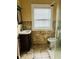Compact bathroom featuring tiled walls, a vanity sink, and a shower with a glass door at , Indianapolis, IN 46201