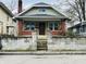 Charming home featuring brick accents, a cozy front porch, and well-maintained landscaping at , Indianapolis, IN 46201
