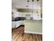 Well-lit kitchen with white cabinets, granite countertops, and modern pendant lighting at , Indianapolis, IN 46201