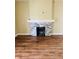Cozy living room with a charming stone fireplace and pristine hardwood floors at , Indianapolis, IN 46201
