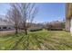 Large grassy backyard with a wooden deck and mature tree at 4655 Welton St, Greenwood, IN 46143