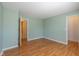 Green bedroom with two doorways and laminate wood floors at 4655 Welton St, Greenwood, IN 46143