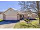 Charming single-story home with a well-manicured lawn and attached two-car garage at 4655 Welton St, Greenwood, IN 46143