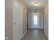 Inviting tiled hallway features a decorative glass front door and white trim at 4655 Welton St, Greenwood, IN 46143