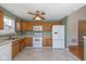 Functional eat-in kitchen features white appliances, oak cabinets, and lots of natural light at 4655 Welton St, Greenwood, IN 46143