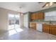 Eat-in kitchen boasts a sliding door to the deck, oak cabinets, and white appliances at 4655 Welton St, Greenwood, IN 46143