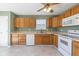 Efficient kitchen with white appliances, oak cabinets, and a large window above the sink at 4655 Welton St, Greenwood, IN 46143